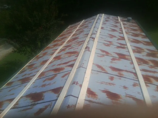 Rusted metal roof panels with new wood purlins before replacement — Storm Damage Roof Repair in Cold Spring by Roofing Brothers